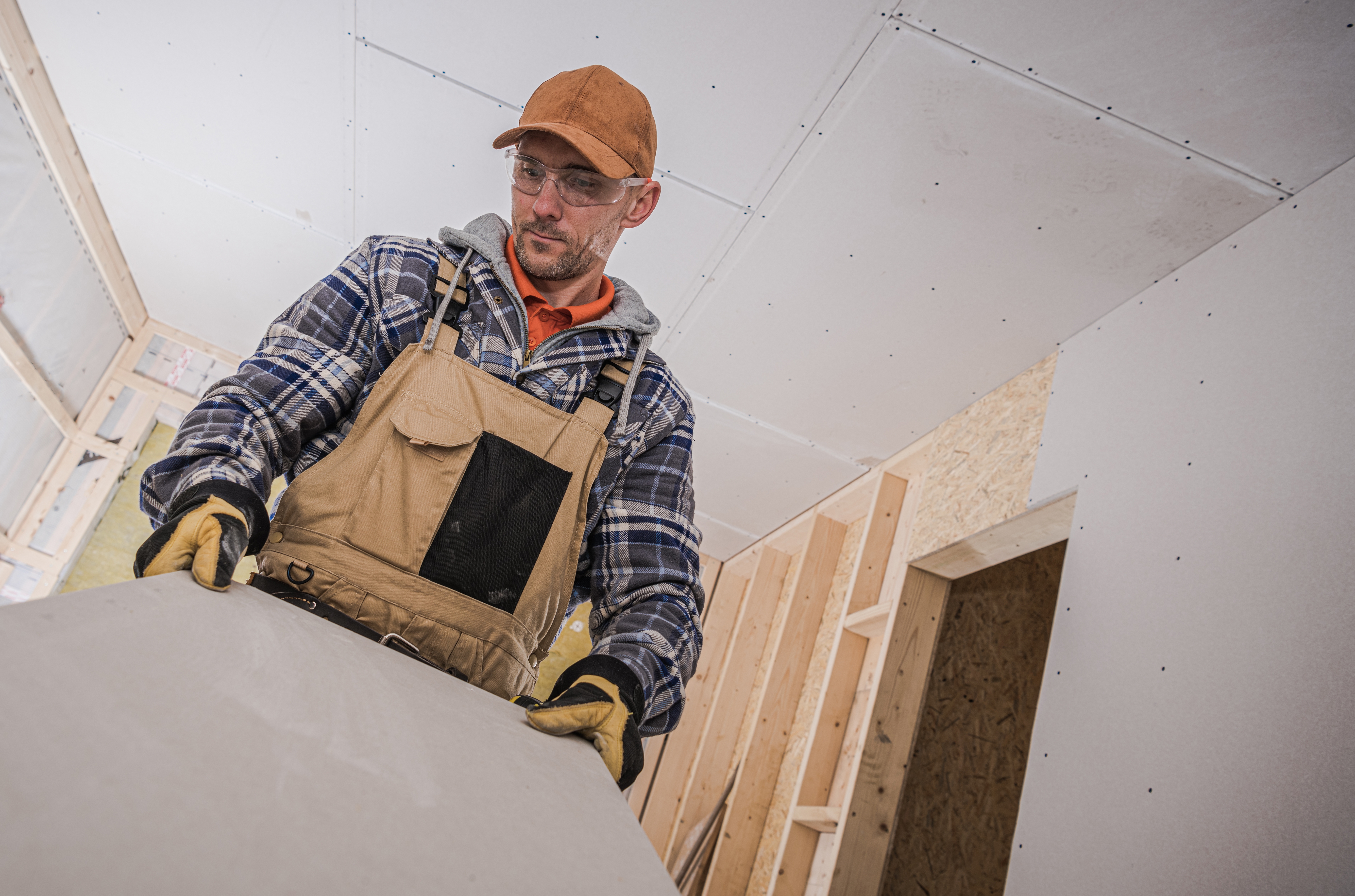 Midwest drywall contractor installing drywall panels in a residential interior construction project, demonstrating expert service for Iowa homes and buildings.